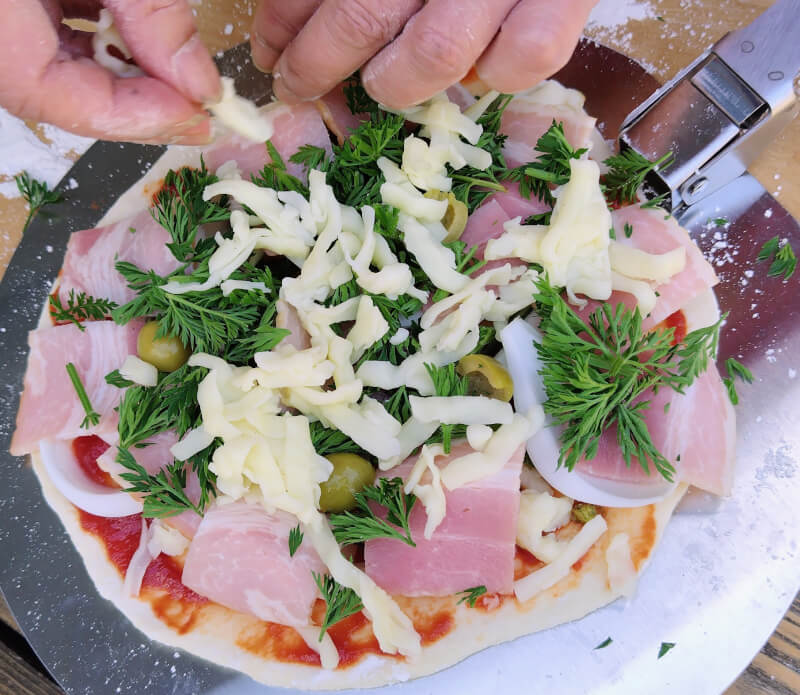 Making pizzas in a wood-fired oven