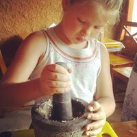 Using the pestle and mortar to grind the spices !